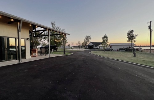 Graford House | 2 bed, 2 bath barndominium with pickle ball court, patio, & dock
