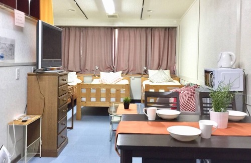 Higashinari Apartment | a room with two toilets and a shower