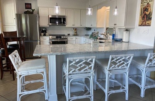 East End Condo | Adorable Beach Cottage. Full size swimming pool shared by four units in building