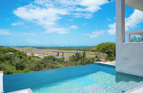 Osbourn Cottage | Affordable luxury, with runway views and tropical breeze.