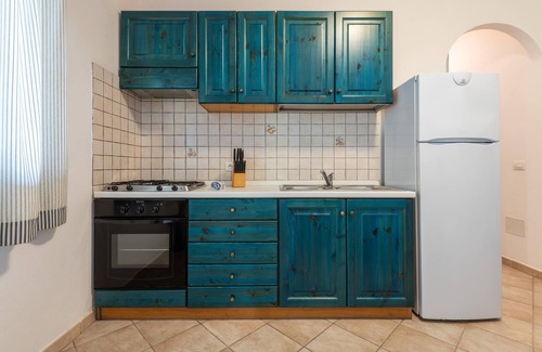 Porto Pino House | Apartment 'Oasi Blu Porto Pino' with Terrace, Garden & Wi-Fi