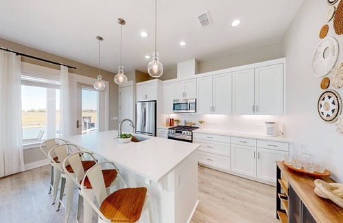 Rockport Villa | Bayfront resort villa with water view, pool, fishing pier, grills, & boardwalk