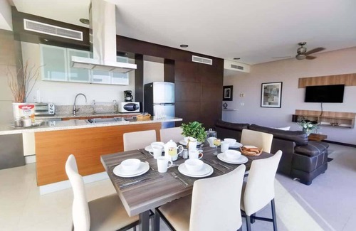 North Hotel Zone Condo | Beachfront Bliss, Gorgeous Pools in Peninsula bldg