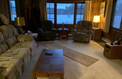 Newport Cabin | Cabin is nestled near the Sugar River in a country setting next to a open field.