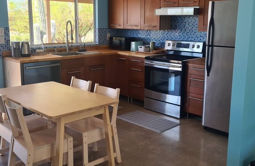 Paradise Valley Village House | Calm saguaro cacti house with palms and oleanders, chirping quails.