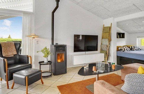Skastrup Strand House | Catch a view of the sea from the terrace of this pleasant and bright vacation home.