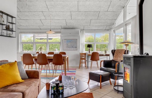 Skastrup Strand House | Catch a view of the sea from the terrace of this pleasant and bright vacation home.