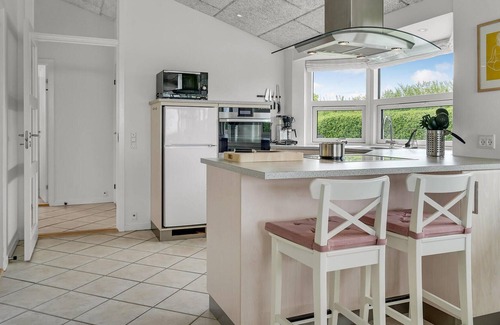 Skastrup Strand House | Catch a view of the sea from the terrace of this pleasant and bright vacation home.