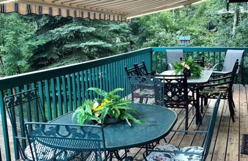 Sunbreaker Cove Cottage | Cedar Log Cottage , nestled in the trees with wrap around deck
