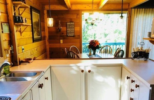 Sunbreaker Cove Cottage | Cedar Log Cottage , nestled in the trees with wrap around deck