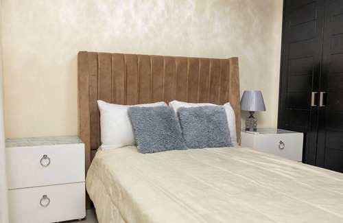 Prado Oriental House | Charming 2-bedroom building in Tranquil Santo Domingo Este with AC
