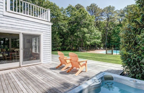 Wainscott Woods House | Classic Summer home with heated pool, hot tub, deck, outdoor seating,...