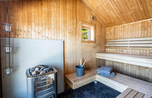 Bjasta House | Coastal gem with beach, wooden sauna & canoes
