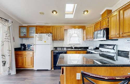 Assateague Pointe House | Coastal living with on-site pool, playground, grills, central AC, & washer/dryer