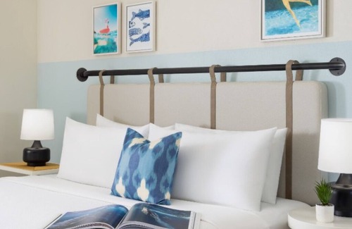 New Town Hotel | Colorful Stay at Blue Flamingo | Poolside Bar, Lawn Games, Music & Fire Pits