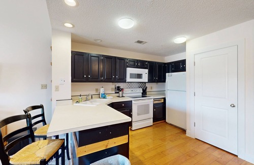 East End House | Comfortable townhome steps from beach with pool access, balcony, & W/D