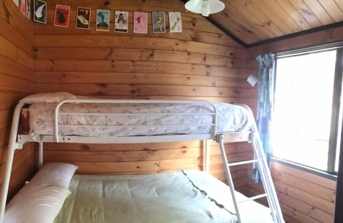Holdens Bay House | Cosy bach, stunning lakefront site, handy location