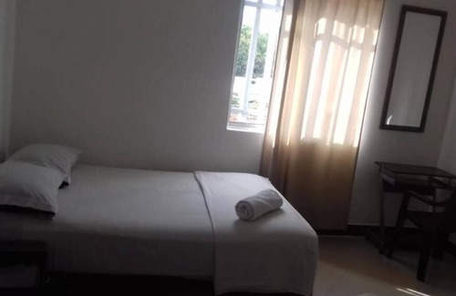 Florida Nueva Hotel | Cozy bedroom in charming Medellín with WiFi