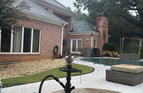 Conyers House | Cozy guest house with pool a table and a swimming pool.