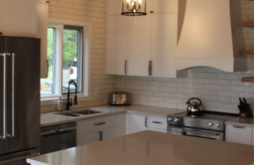 Hillside Beach Cabin | Cozy modern 4 season lake front cottage w/ hot tub