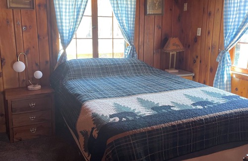Itasca County Resort | Cozy queen bed in main Resort Lodge