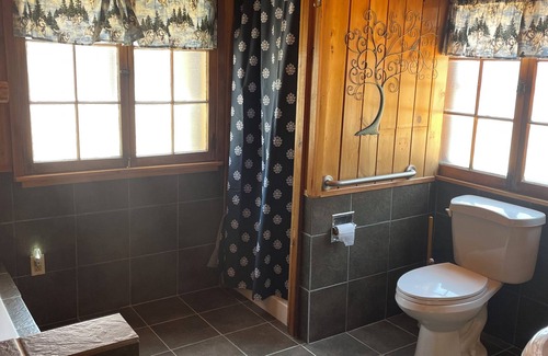 Itasca County Resort | Cozy queen bed in main Resort Lodge