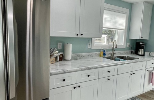 Oscoda Cottage | Cozy riverfront cottage with an easy beach-inspired coastal MI vibe!
