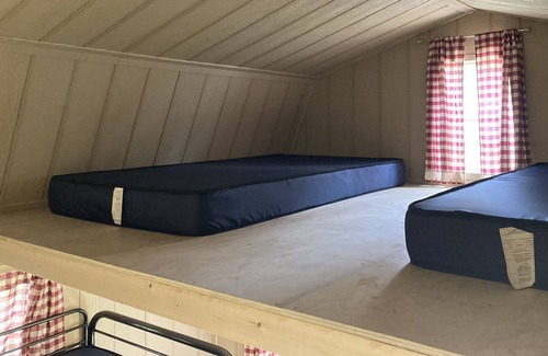 Front of Yonge RV Rental | Cozy solar bunkie cabin located happy green acres campground