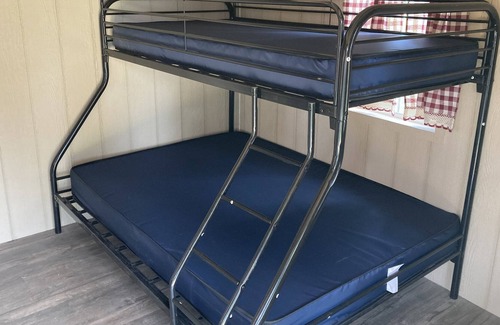 Front of Yonge RV Rental | Cozy solar bunkie cabin located happy green acres campground