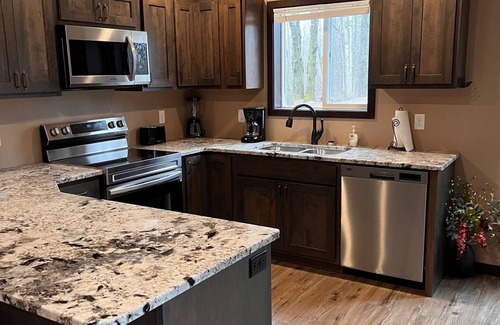 Bemidji House | Cozy two level home - 2 minutes from beach on private wooded lot.