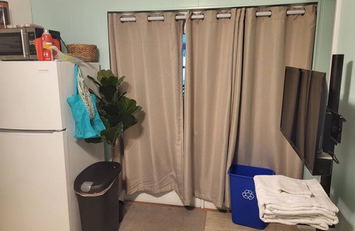 Goldenrod House | Cozy XL room with kitchenette, dining table, couch, and smart tv, shared bath