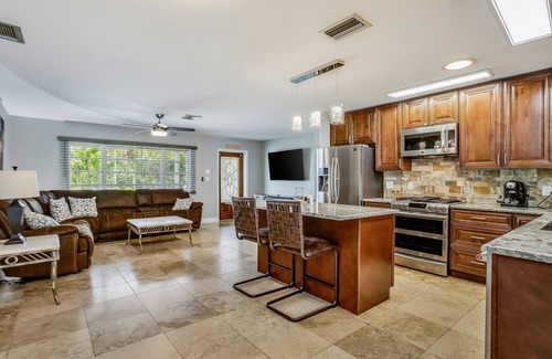 Fort Myers House | Creekside retreat with screened pool, patio, grill, firepit, canoe + kayak, & AC