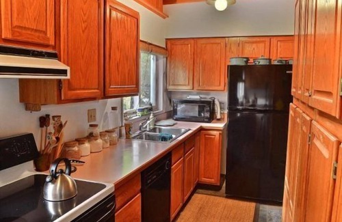 Wapiti Cabin | Creekworks Cabin- Wapiti Valley, surrounded by trees with creek access