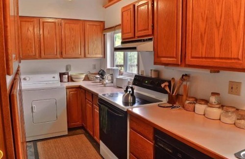 Wapiti Cabin | Creekworks Cabin- Wapiti Valley, surrounded by trees with creek access