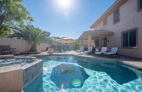 Roosevelt Park House | Custom home with 5 Beds & 5.5 Baths! A heated pool & spa make the backyard feel like a resort