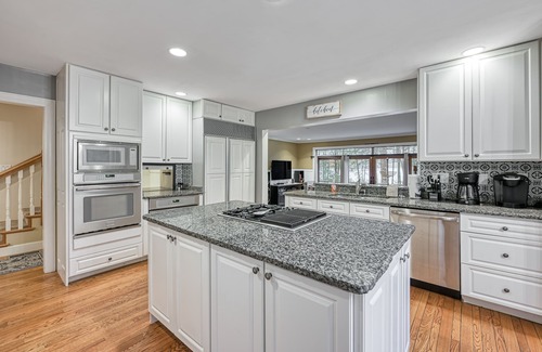 McHenry House | Enchanting waterfront home with hot tub, game room, fireplace, & washer/dryer