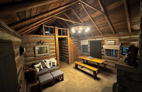 Aurora Cabin | Enjoy a cozy getaway in a rustic log cabin on Kentucky Lake. With Hottub