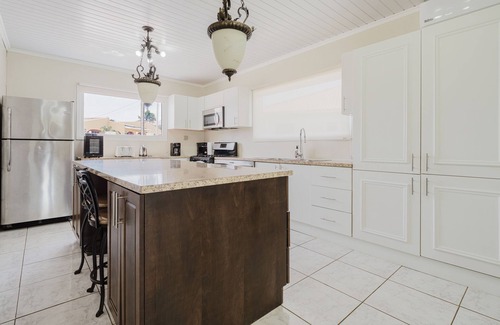 Shiribana Villa | Escape to Happy Daze Villa, a sunny 3-bedroom, 2-bathroom vacation home in a charming yellow setting