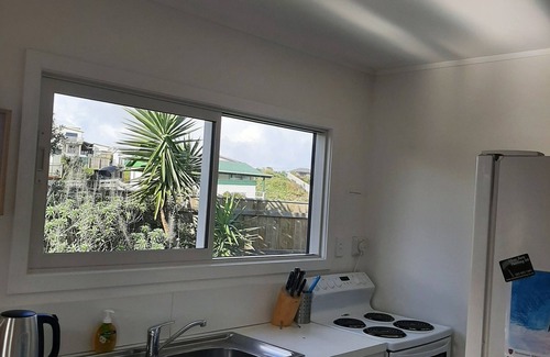 Waitarere Beach House | Family friendly, fully fenced bach, close to the beach, shops and playground.