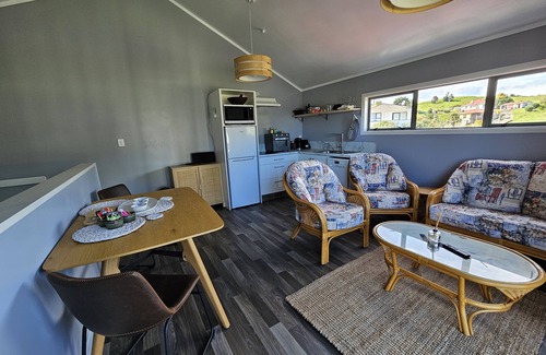 Maketu Apartment | Family room, come and enjoy the magical sunset on the balcony, Pet Friendly