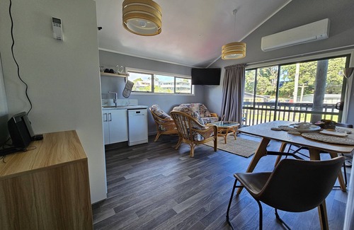 Maketu Apartment | Family room, come and enjoy the magical sunset on the balcony, Pet Friendly