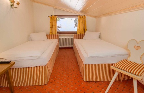 Lech am Arlberg Hotel | Family Suite with sloping ceilings and forest views - Hotel Kristberg