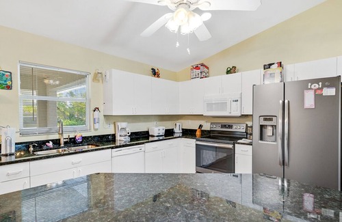 Biggar House | Fenced, private, family friendly villa with exotic poolside views near airport.