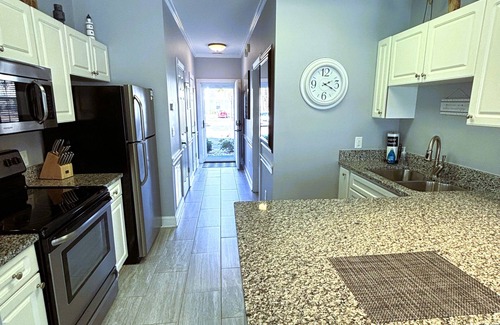 Central Myrtle Beach Condo | First Floor Updated Coastal Summer Retreat at Magnolia Place - Pool View