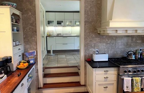 New Canaan House | Fountain Courtyard and Fireplace Kitchen