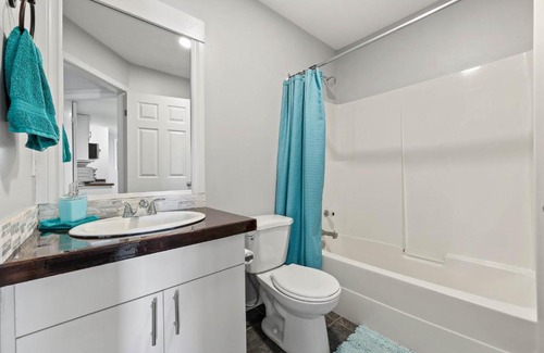 Kamloops House | Guest suite with patio that backs onto greenbelt