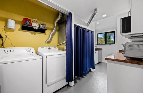 Kamloops House | Guest suite with patio that backs onto greenbelt