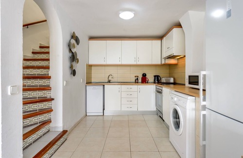 Santa Eulalia del Rio House | Holiday Home "Casita en Cala Llonga" with Sea View, Shared Garden & Pool