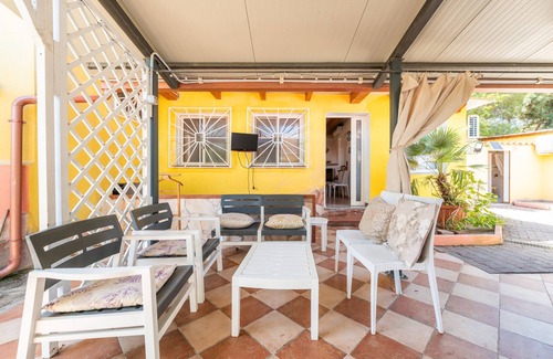 Porto Pino House | Holiday Home 'Villa Mimosa' with Private Terrace, Private Garden and Air Conditioning