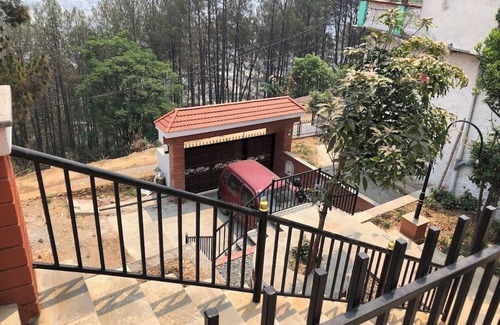Kirtipur House | Home is located on the side of a mountain near a famous Buddhist monastery. n